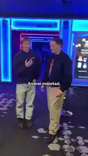 In a vibrant indoor setting with neon lights, two men from the Estonian content group Kozip Eesti discuss a viral social media challenge. One man shows his phone to the other, revealing a TikTok video that has garnered over 6,000 likes. They express excitement about the popularity of the video, which they claim was posted just three weeks ago. The conversation centers around reaching a milestone of 10,000 likes, a common goal for creators seeking engagement. This moment captures the real-time reaction of popular creators to their audience's support. by @kozipeesti with Original Sound by kozipeesti