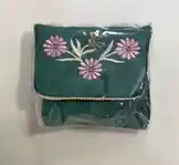 A beautifully hand-embroidered green pouch is revealed in a slow, satisfying unboxing sequence. Delicate pink flowers and silver thread details stand out against the rich fabric. The camera focuses on craftsmanship and texture, ideal for viewers interested in handmade accessories, embroidery art, or unique gift ideas. by @hawra3060 with original sound