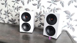 Cambridge Audio's L/R S speakers on a desk. The speakers are white with black tweeters.