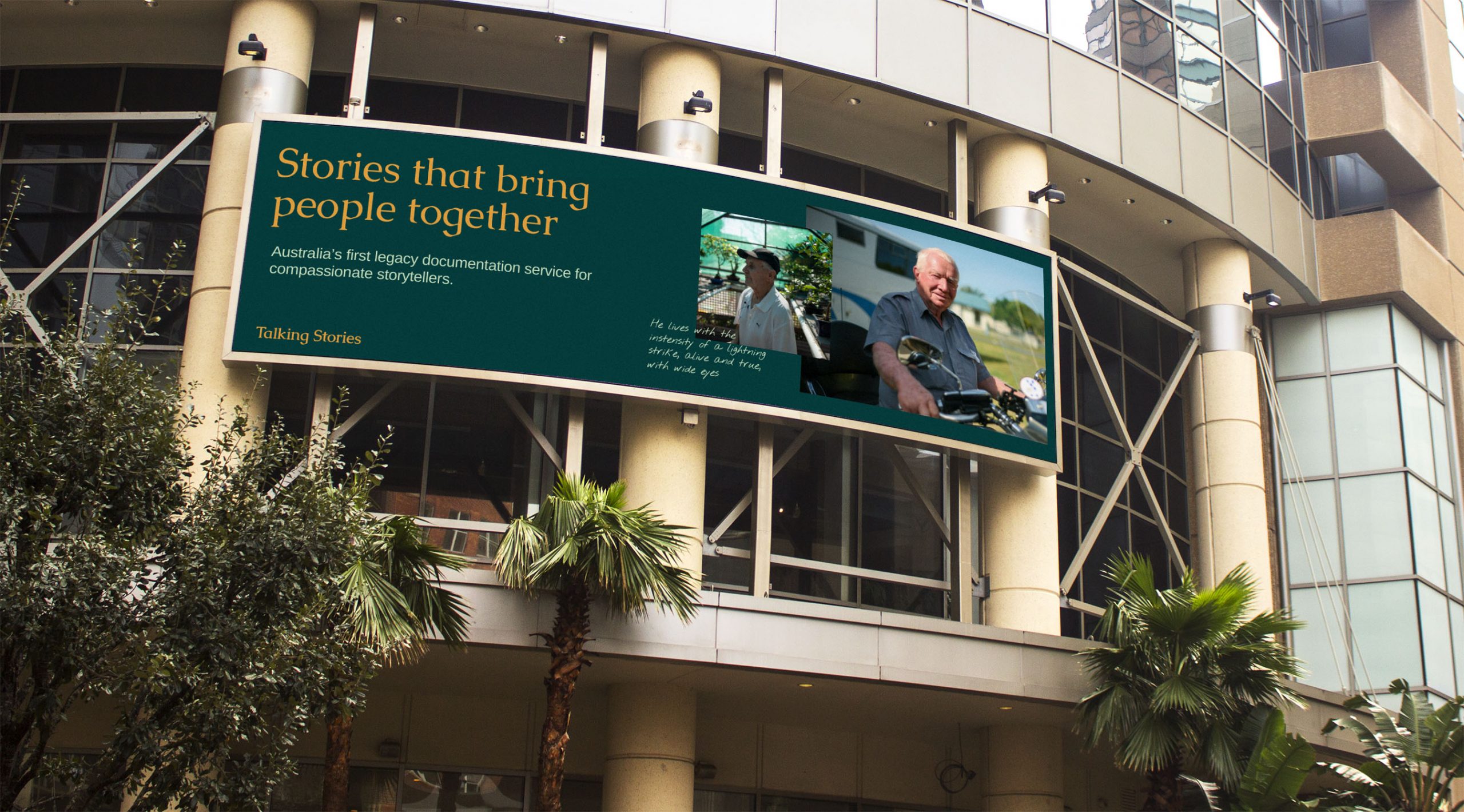 Billboard image of a man in a motorcyle that says "Stories that bring people together"