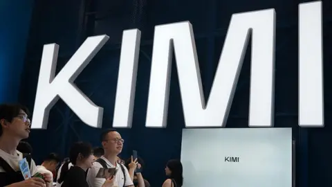 Visitors at a trade show in Shanghai visit a booth with the Kimi sign displayed in large block letters