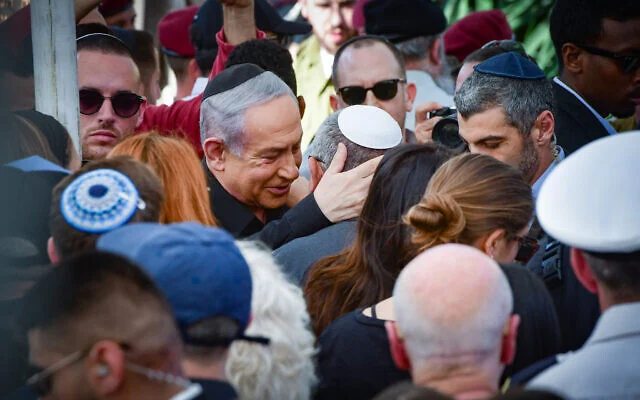 Prime Minister Benjamin Netanyahu (center-left) consoles war cabinet minister and former IDF chief of staff Gadi Eisenkot (center in white kippa) at the funeral of Eisenkot's son, Master Sgt. (res.) Gal Meir Eisenkot, in Herzliya on December 8, 2023. Gal Eisenkot was killed December 7 during an IDF ground operation in the Gaza Strip. (Avshalom Sassoni/Flash90) Prime Minister Benjamin Netanyahu (center-left) consoles war cabinet minister and former IDF chief of staff Gadi Eisenkot (center in white kippa) at the funeral of Eisenkot's son, Master Sgt. (res.) Gal Meir Eisenkot, in Herzliya on December 8, 2023. Gal Eisenkot was killed December 7 during an IDF ground operation in the Gaza Strip. (Avshalom Sassoni/Flash90)