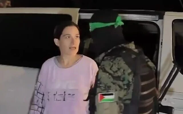 Hostage Rimon Buchshtab-Kirscht speaks to her Hamas captor as she is being released to the Red Cross in Gaza, November 28, 2023. (Screenshot via Al Jazeera) Hostage Rimon Buchshtab-Kirscht speaks to her Hamas captor as she is being released to the Red Cross in Gaza, November 28, 2023. (Screenshot via Al Jazeera)