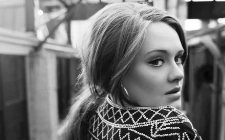 Adele poses confidently in a striking black-and-white portrait, showcasing her distinctive style. This HD wallpaper captures the essence of her musical artistry beautifully.